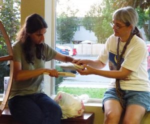 Judy showing Mirian how to hand card